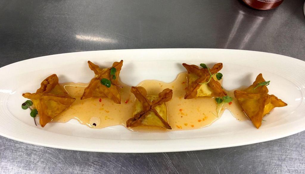 Crab & Cheese · Crisp wonton filled with Philadelphia cream cheese, crab, shrimp and scallion paired with plum sauce.