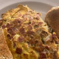 Wild Turkey Omelet · Turkey sausage, turkey bacon, and American cheese. Made with three eggs, served with your ch...