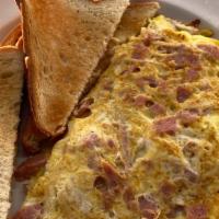 Western Omelet · Ham, peppers, and onions. Made with three eggs, served with your choice of home fries or gri...