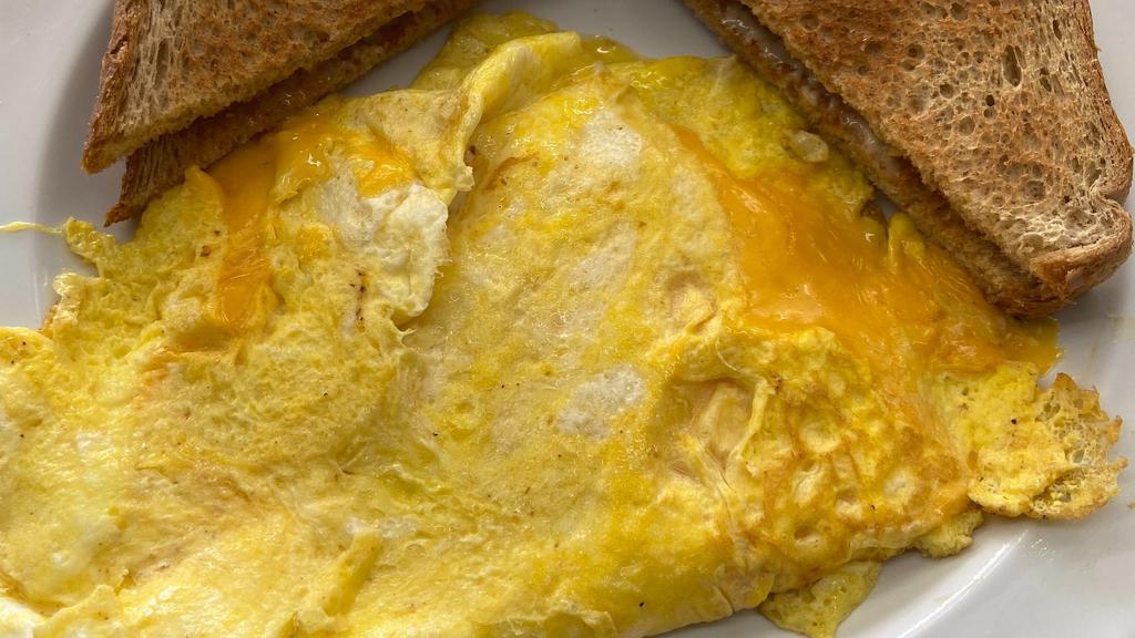 Classic Cheese Omelet · Made with three eggs and American Cheese. Served with your choice of grits or home fries and toast.