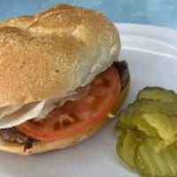 California Cheese Burger · Classic cheese burger with lettuce, tomatoes, onions, and mayo. Quarter pound burger on a ha...
