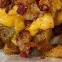 Smothered Home Fries · Home fries topped with onions, peppers, bacon & cheese.