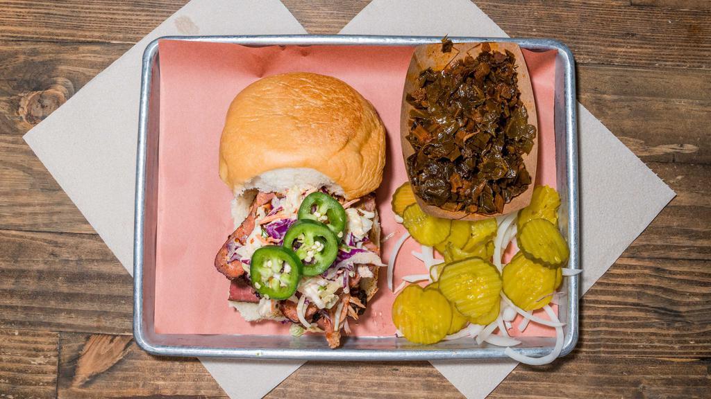 The “Pitmaster” · Brisket+Pulled pork+ Sausage, topped
with slaw, bbq sauce & fresh sliced jalapeños