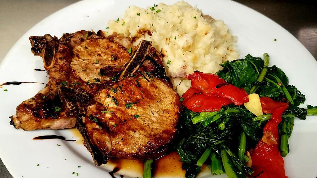 Pork Chops Balsamico · Broiled pork chops served with broccoli rabe, roasted red peppers, garlic mashed potatoes, and drizzled with balsamic reduction.