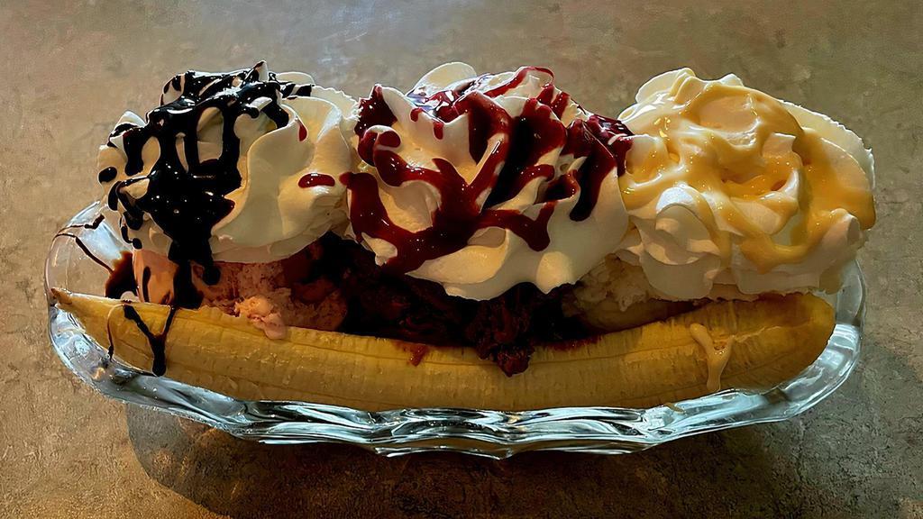 Banana Split · Hand made specialty with walnuts, fresh banana and 3 scoops of ice cream topped with whipped cream and drizzled with flavored syrup