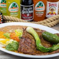 Carne Asada · Delicious broiled steak topped with grill jalapeño and green onion. Served with rice, beans,...