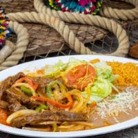 Fajitas De Res · Strips of grilled steak with onions and bell peppers. Served with rice, beans, green salad, ...