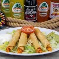 4 Taquitos · Four rolled fried corn tortillas stuffed with your choice of shredded beef or shredded chick...