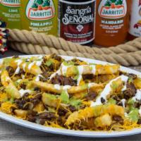 Steak Fries · Steak and fries topped with cheese, sour cream and avocado sauce.
