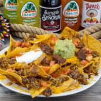 Nachos · Nachos with your choice of meat, beans, cheese, tomato, sour cream, and guacamole.
