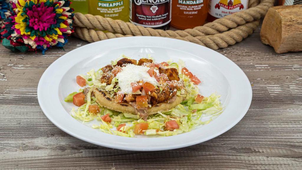 Sope · Fried thick corn base with your choice of meat, beans, cabbage, tomatoes, sour cream, and cotija cheese.