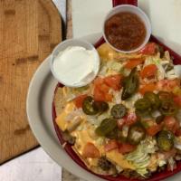 Nachos · Chips covered in queso, topped with tomatoes, cheddar cheese, lettuce black beans and jalape...