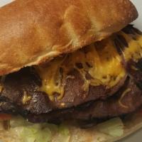 Roast Beef-N-Cheddar · Cajun roast beef topped with melted cheddar cheese, served on a ciabatta roll dressed with h...