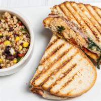 Chicken Saltimbocca Panini · Grilled chicken breast topped with arugula, ham, provolone, and garnished with sun-dried tom...