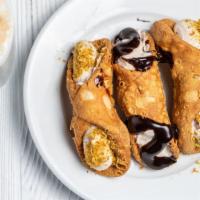 Homemade Cannoli · Three pastry shells filled with a traditional Italian filling dipped in chocolate or pistachio