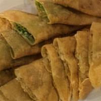 Bowlawni · Pan fried twin pastry shells, filled with leeks and spiced potatoes. Served with yogurt garl...