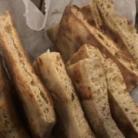 Naan By The Basket · Our house made fresh baked bread.