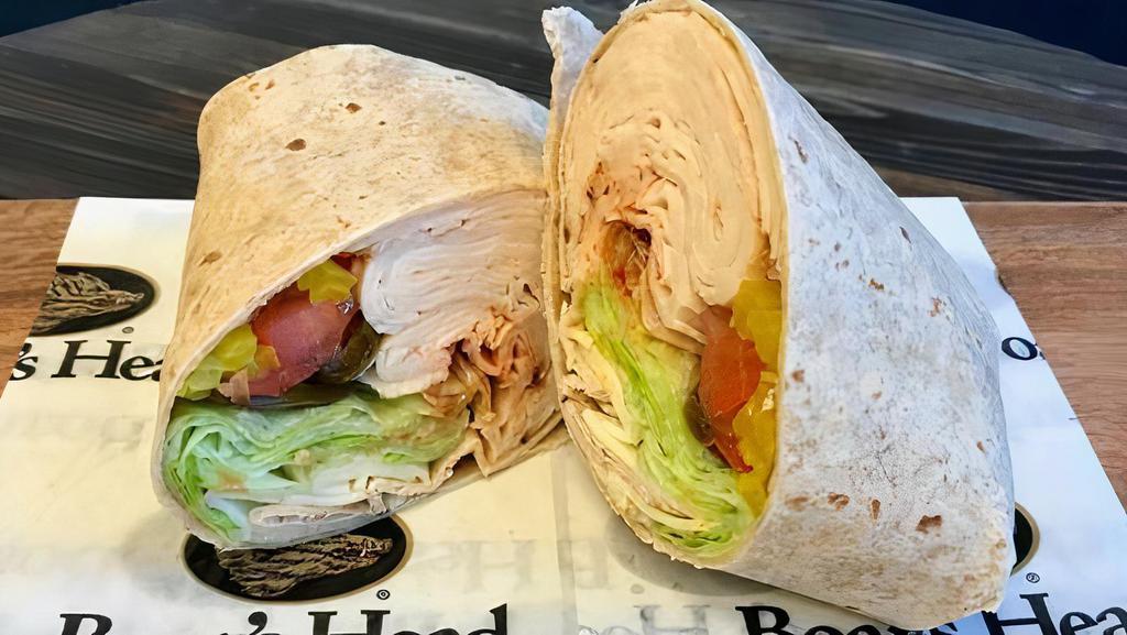 Fire Ball · Blazing buffalo chicken, jalapeño pepper jack cheese, lettuce, tomato, banana peppers, jalapeños, and jalapeño pepper sauce in a honey wheat wrap