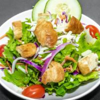 Garden Salad · Fresh greens with cucumbers, tomatoes, red onion, carrots and cabbage. Topped with croutons ...