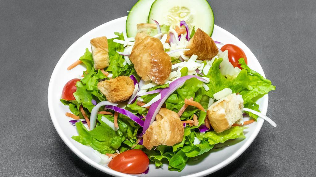 Garden Salad · Fresh greens with cucumbers, tomatoes, red onion, carrots and cabbage. Topped with croutons and Monterey Jack cheese.