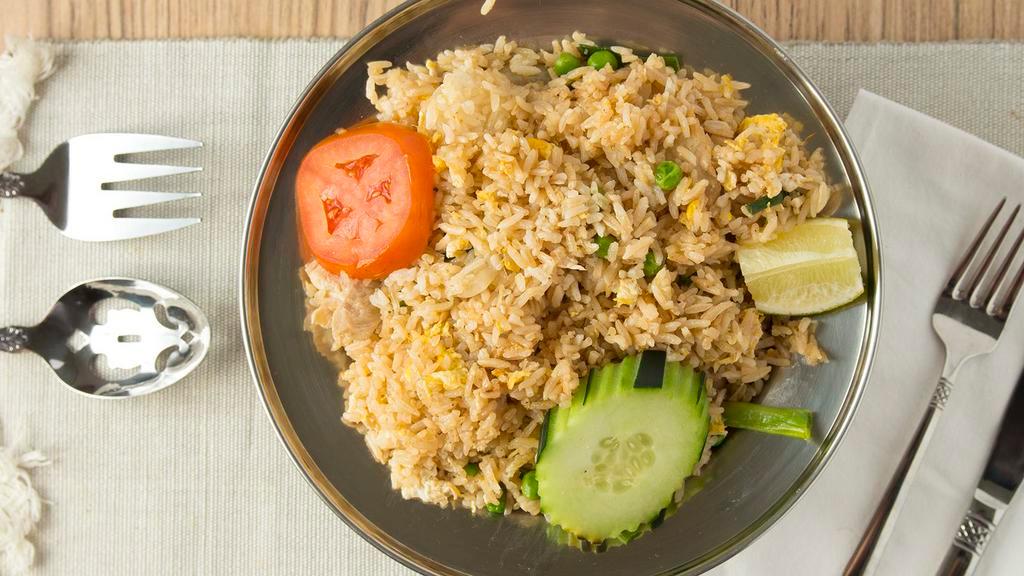 Thai Fried Rice · Vegan. A classic thai stir-fried jasmine rice with onions, tomatoes, scallions, peas and carrots.