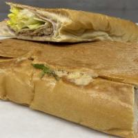 Cubano · Shredded pork, ham, swiss cheese, lettuce, tomato, and mayonnaise on foot long french bread.