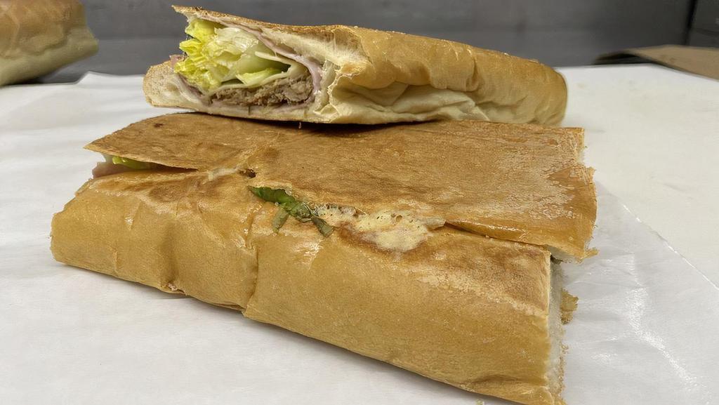 Cubano · Shredded pork, ham, swiss cheese, lettuce, tomato, and mayonnaise on foot long french bread.