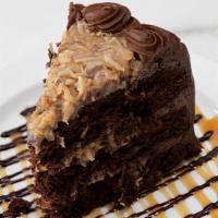 German Chocolate Cake, Slice · Moist chocolate cake with our homemade caramel-coconut-pecan filling. Iced with chocolate bu...