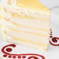 Luscious Lemon Cake, Slice · Homemade lemon curd between thin white cake layers brushed with lemon syrup and iced with le...