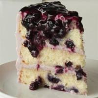 Lemon Blueberry Cake, Slice · Lemon cake layers studded with fresh blueberries, iced with blueberry cream cheese frosting ...