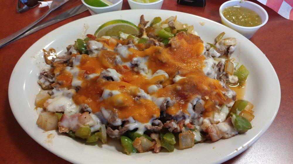 Enchilada Platter  · Two corn tortillas with choice of red or green sauce. Topped with onion, cilantro, queso fresco, and sour cream. Served with black or pinto refried beans and rice.