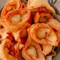 Crab Rangoon · Crab and cream cheese wontons pinched into little purses and deep fried, served with sweet a...