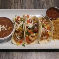 Fish Tacos · blackened tilapia, mango salsa, re chile tomatillo, flour tortilla - served 3 up