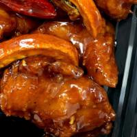 Orange Chicken · Spicy. Breaded chicken lightly fried, sautéed with brown sweet-spicy sauce hint of orange pe...