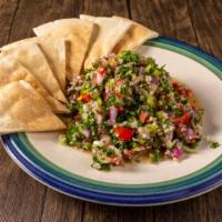 Tabouli · Chopped tomato onion parsley lemon juice olive oil bulgur and herbs. served with hot pita br...
