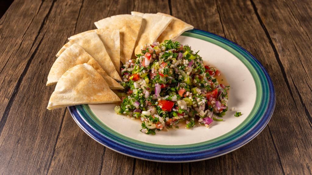Tabouli · Chopped tomato onion parsley lemon juice olive oil bulgur and herbs. served with hot pita bread.