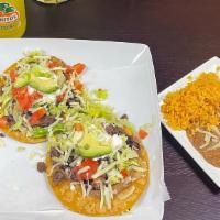 Tostada Dinner · 2 open faced hard shell tortillas with choice of meat, beans, lettuce, tomato, cheese, avoca...