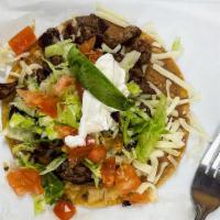 Tostada · Open faced hard shell tortilla with choice of meat, beans, lettuce, tomato, avocado, and sou...