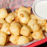 Cheese Curds · Baby nuggets of white cheddar, straight from Badger State. Beer-battered and lightly fried w...