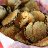 Fried Pickles · Thinly sliced dill pickle chips dipped in homemade cornmeal breading & lightly fried. Served...