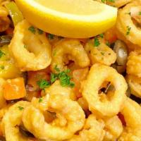 Sicilian Style Calamari · Crispy calamari tossed with tomatoes, olives, banana peppers, garlic butter, served over lin...