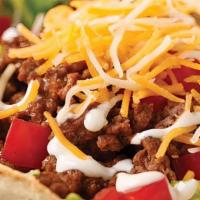 Taco Salad · Seasoned Mexican beef, lettuce, tomato, black olives, shredded jack cheddar cheese, served i...