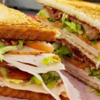 Club Sandwich · Grilled chicken, Cajun chicken, or Turkey, on white toast, Applewood bacon, lettuce, tomato,...