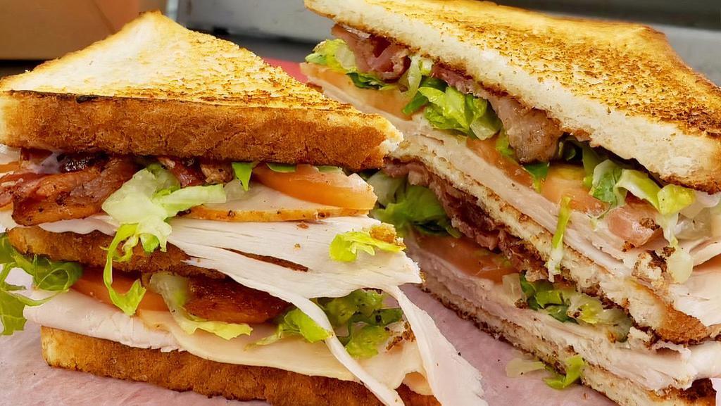 Club Sandwich · Grilled chicken, Cajun chicken, or Turkey, on white toast, Applewood bacon, lettuce, tomato, mayo