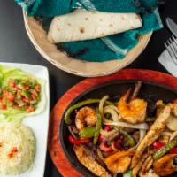 Fajita Mixta · Steak, chicken, shrimp, served with rice, beans, pico de gallo, guacamole, sour cream, and h...