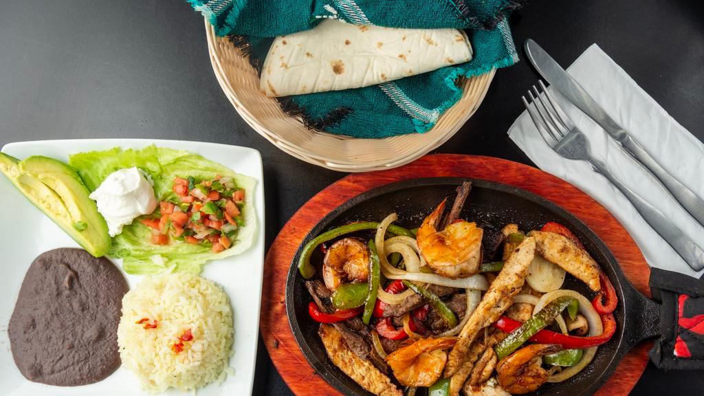 Fajita Mixta · Steak, chicken, shrimp, served with rice, beans, pico de gallo, guacamole, sour cream, and handmade tortillas.