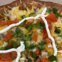 Steak Mexican Pizza · Flour tortilla covered with beans, cheese and Steak. Topped with tomato, onions and cilantro