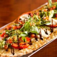 Caprese Flatbread · brushed with extra virgin olive oil & fresh herbs, layered with oven roasted tomatoes, parme...
