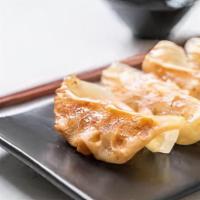 Gyoza · Pan fried Japanese meat dumpling.