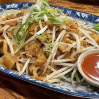 Kua Gai · Spicy, Gluten-free.Sautéed flat noodles with eggs, garlic, preserved turnips, bean sprouts s...